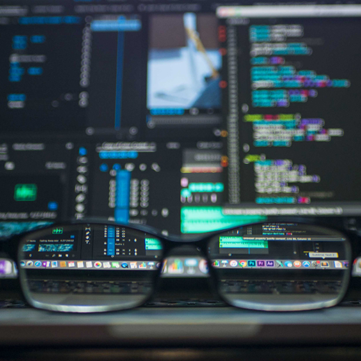 Eyeglasses reflecting a computer screen with code